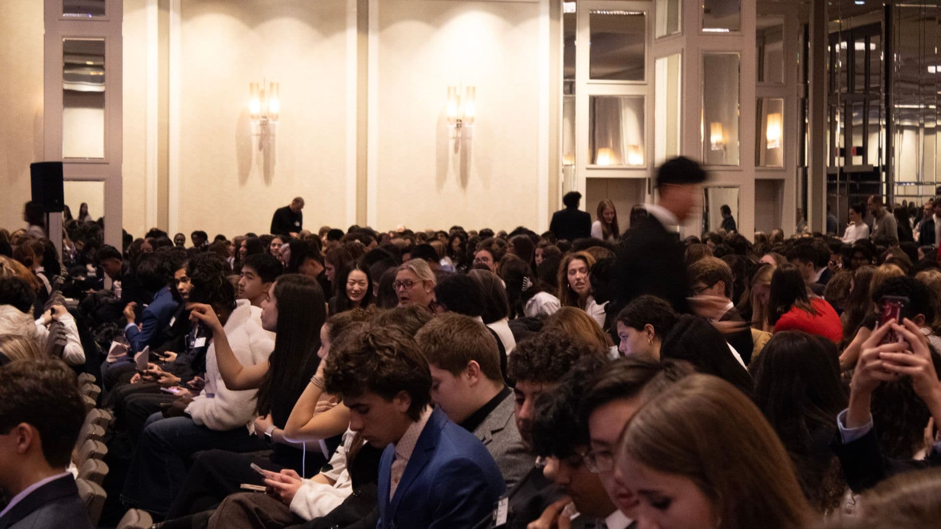 A full Model United Nations conference room with student delegates